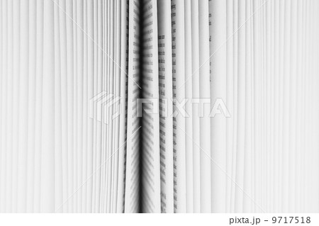 Close up of a book with the pages slightly fanned out, with a black paper edge in the centre. Close up of a book with the pages slightly fanned out, with a black paper edge in the centre. 9717518