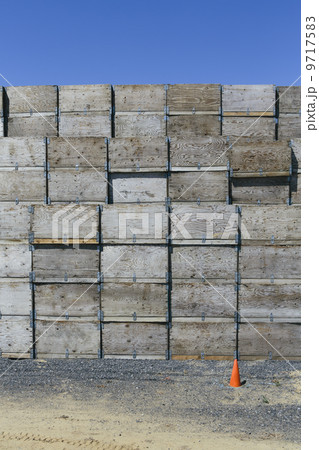 Large stack of fruit boxes for harvesting and storing apples, traffic cone in foreground, near Quincy 9717583