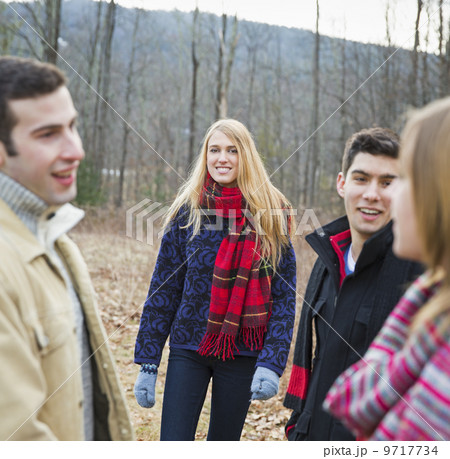 A group of four people outdoors on a winter day. A group of four people outdoors on a winter day. 9717734