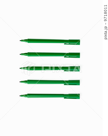 Office supplies. Green coloured pens, felt nibs and pen top cases, arranged in a row. Office supplies. Green coloured pens, felt nibs and pen top cases, arranged in a row. 9718011