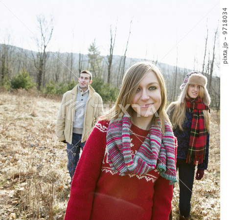 A group of three people, a man and two women, on a walk on a winter day. 9718034