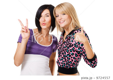 Two young beautiful woman showing "Thumbs up" and ''Peace'' sign 9724557