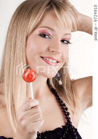 Funny young woman with a lollipop 9724910