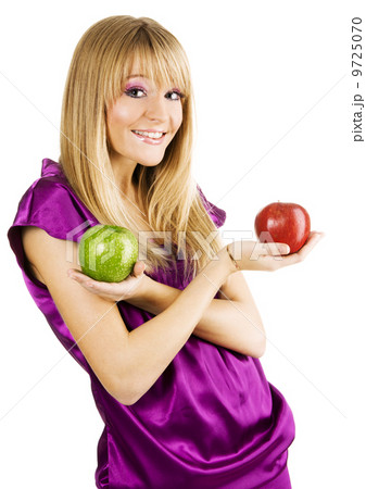 Young beautiful woman holding two apples 9725070