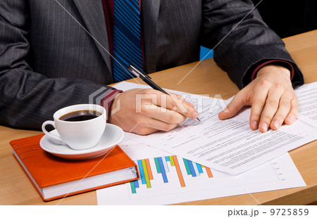 Businessman's table covered with documents Businessman's table covered with documents 9725859