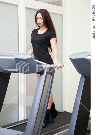 Beautiful woman running in a gym Beautiful woman running in a gym 9726008