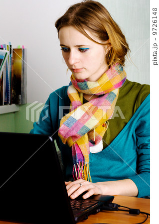 Pretty young woman working at laptop 9726148