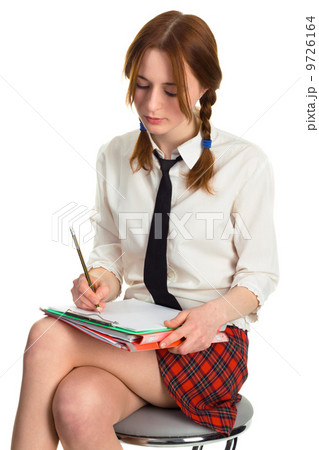Beautiful lady writing on a worksheet Beautiful lady writing on a worksheet 9726164