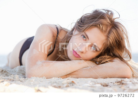 Beautiful model lying in sand Beautiful model lying in sand 9726272