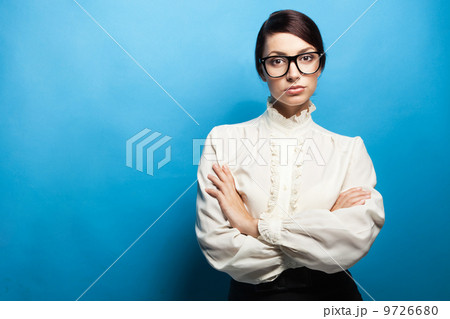 Strict woman in large glasses 9726680