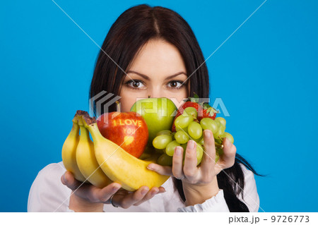 Beautiful young girl with a bunch of fruits Beautiful young girl with a bunch of fruits 9726773