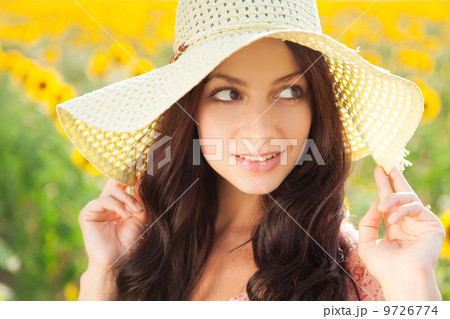 Beautiful lady walking in sunflower field 9726774