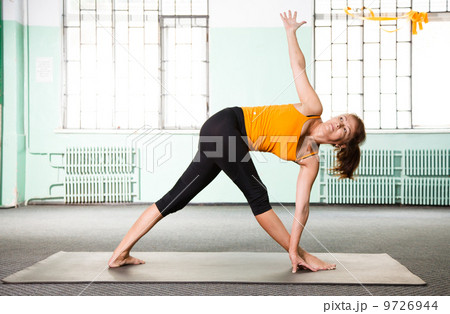 Mature woman exercising yoga 9726944