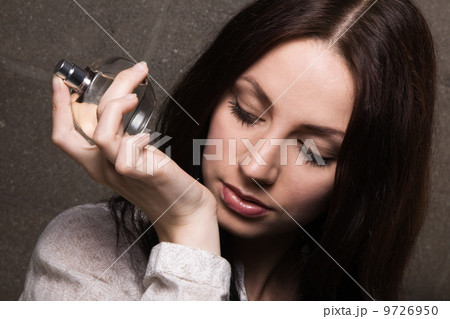 Beautiful lady with a bottle of perfume 9726950