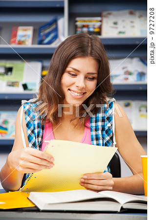 Beautiful female student in a university library 9727208