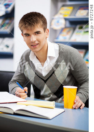 Handsome male student in a university library Handsome male student in a university library 9727248
