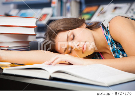 Beautiful female student in a library Beautiful female student in a library 9727270