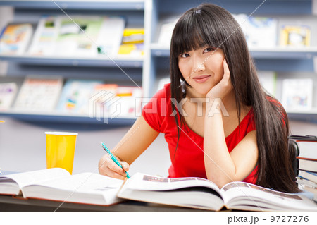 Beautiful female student in a library Beautiful female student in a library 9727276