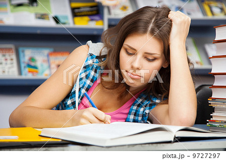 Beautiful female student in a library Beautiful female student in a library 9727297