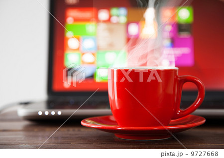 Laptop and a cup of coffee Laptop and a cup of coffee 9727668