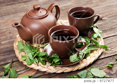 Tea with mint on a wooden table Tea with mint on a wooden table 9727877