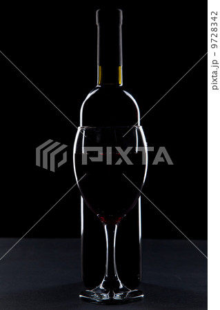 Wine glass and bottle on black background 9728342