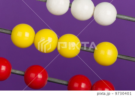 Close-up of an abacus on a purple background 9730401