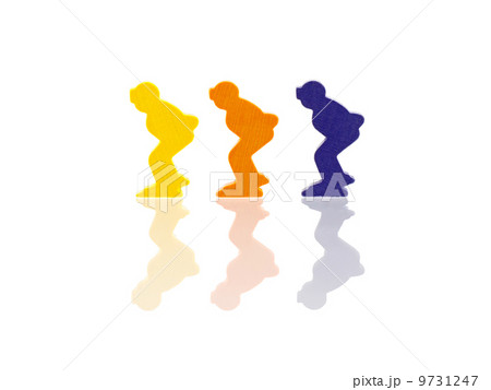 Three colored pawns isolated on a white background 9731247