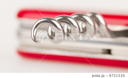 Red swiss army knife isolated, focus on corkscrew 9731330