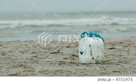 Container with acid on a beach 9731973