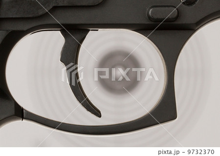 The trigger of a handgun with a shooting target 9732370