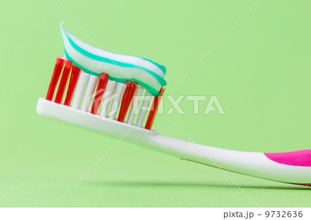 A pink toothbrush with toothpaste A pink toothbrush with toothpaste 9732636