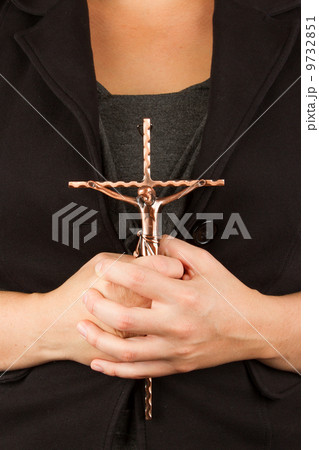 Woman in black with the cross in hands 9732851