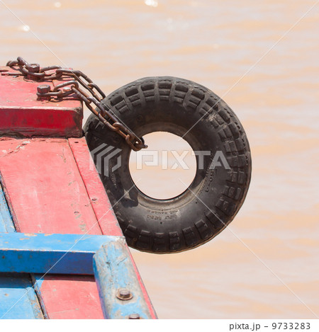 Fender on a red boat in the Mekong delta 9733283
