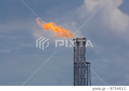 Burning oil gas flare during sunset Burning oil gas flare during sunset 9734012