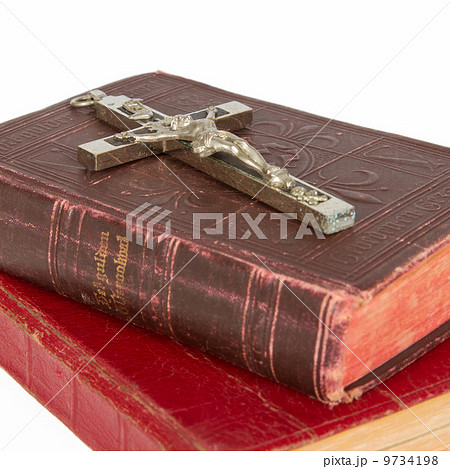 Old antique bible and cross on a white background Old antique bible and cross on a white background 9734198