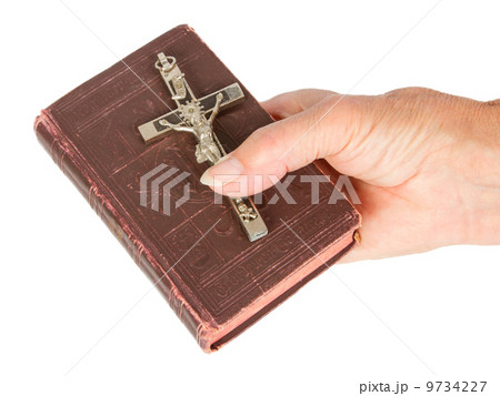 Old hand (woman) holding a very old bible Old hand (woman) holding a very old bible 9734227