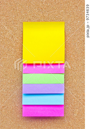 Six colorful sticky notes on wooden board. 9734639
