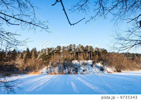 frozen river and trees in winter season frozen river and trees in winter season 9735343