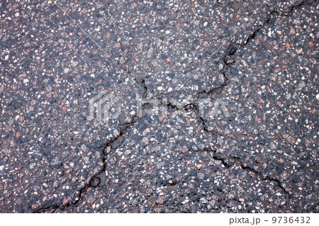 Old wet worn and cracked asphalt 9736432