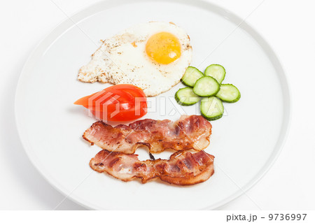 fried eggs, bacon and vegetables on white background 9736997