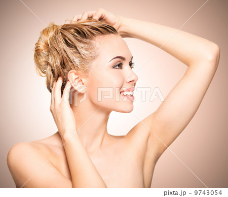 Portrait of an young woman washing her hair 9743054