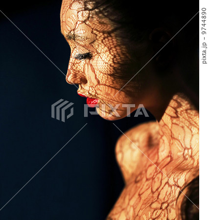 Art Deco. Ethnic Woman's Face with Reflex of Openwork Lace - Fancy Makeup Art Deco. Ethnic Woman's Face with Reflex of Openwork Lace - Fancy Makeup 9744890