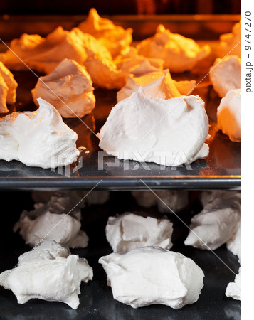 cooking of sweet dessert meringue on oven trays cooking of sweet dessert meringue on oven trays 9747270