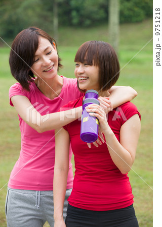 asian girl friends having fun after a workout outdoor 9751218