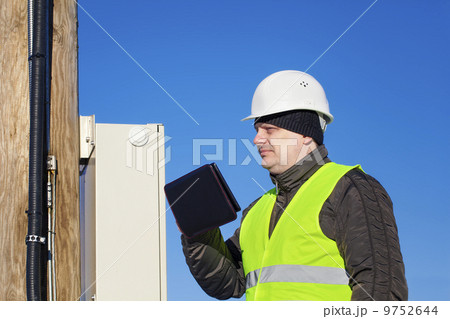 Electrician inspect electric lines technical quality Electrician inspect electric lines technical quality 9752644