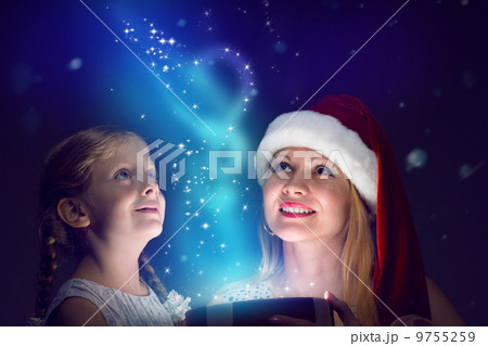 mother and daughter opened a box with a gift mother and daughter opened a box with a gift 9755259