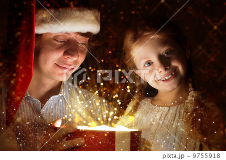 father and daughter opened a box with a gift father and daughter opened a box with a gift 9755918