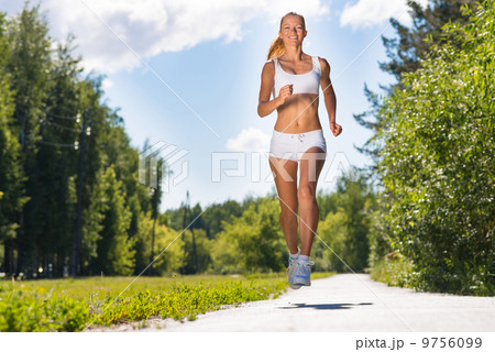young athletic woman running on the road 9756099