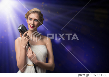 attractive female singer with microphone 9756100